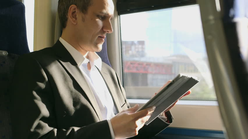iPad on the Train Businessman